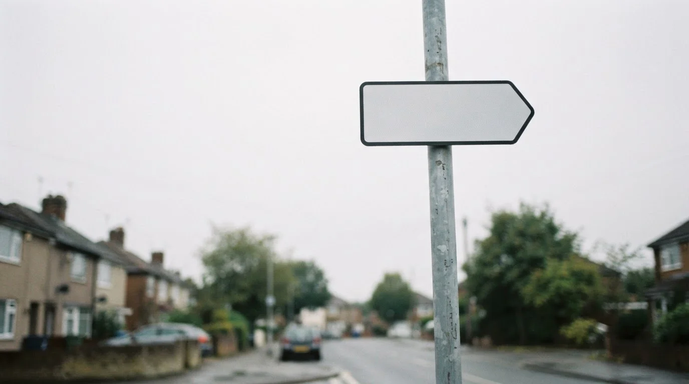 One-way street sign against a plain overcast sky